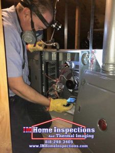 Inspecting a furnace in an attic 